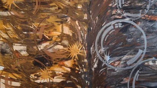 Acrylic artwork of gold stars and silver rings on wood