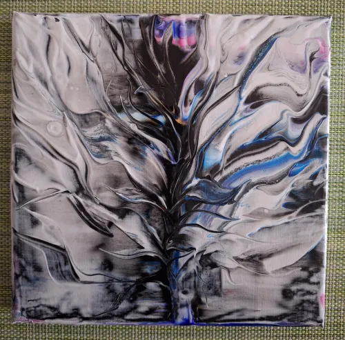 Abstract acrylic pour painting in black, white, and blue.