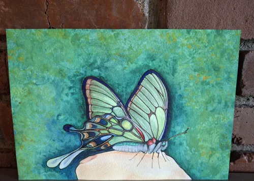Watercolor and pencil painting of a pale green butterfly on a finger