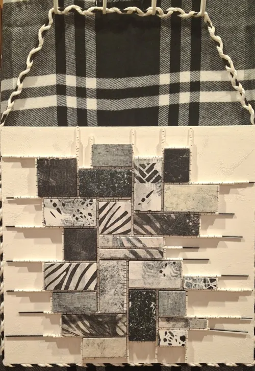 Diverse monochromatic patterned tiles made with acrylic and wood and paper straws